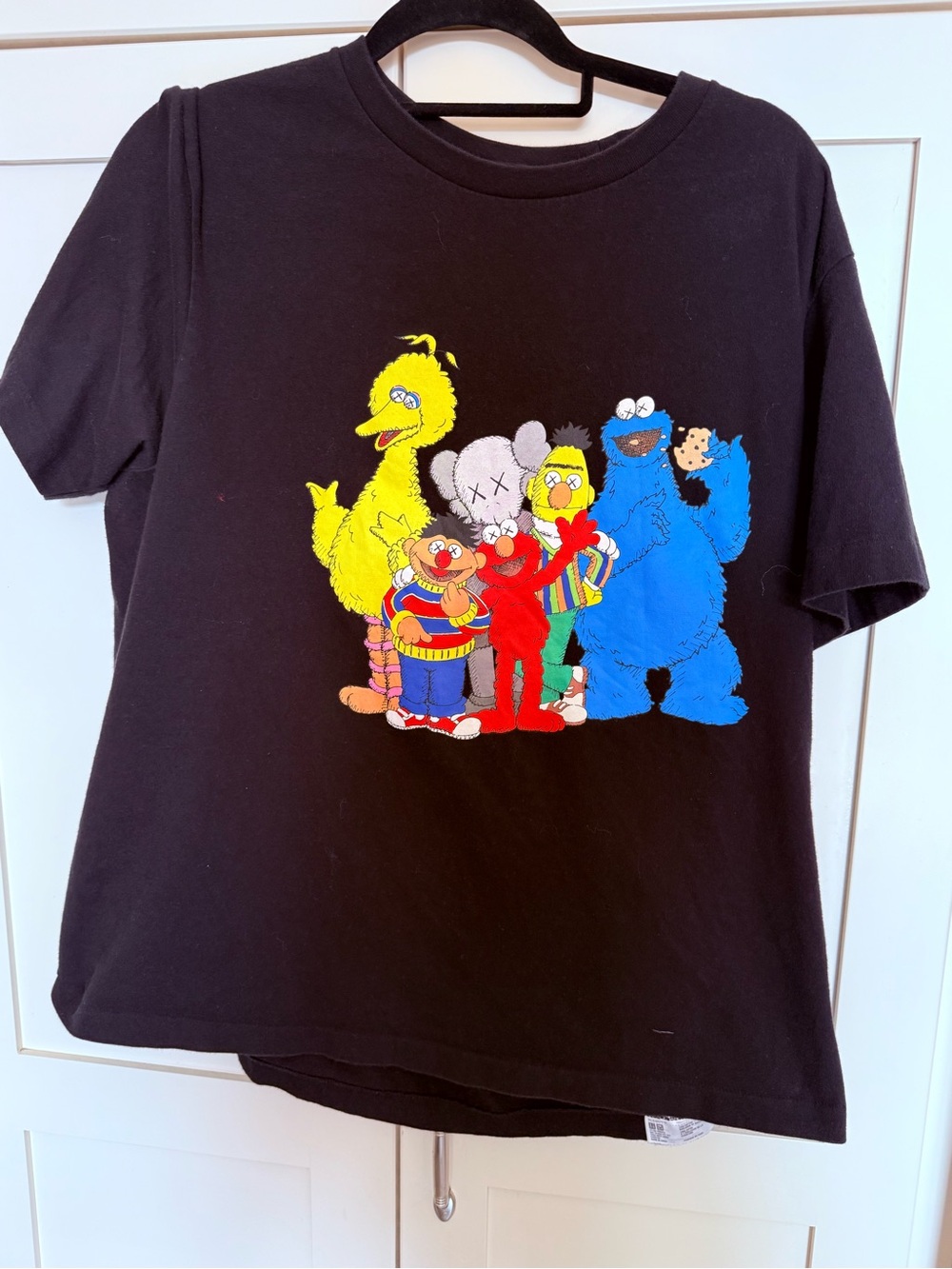 KAWS Black Tee with Colorful Sesame Character Graphic